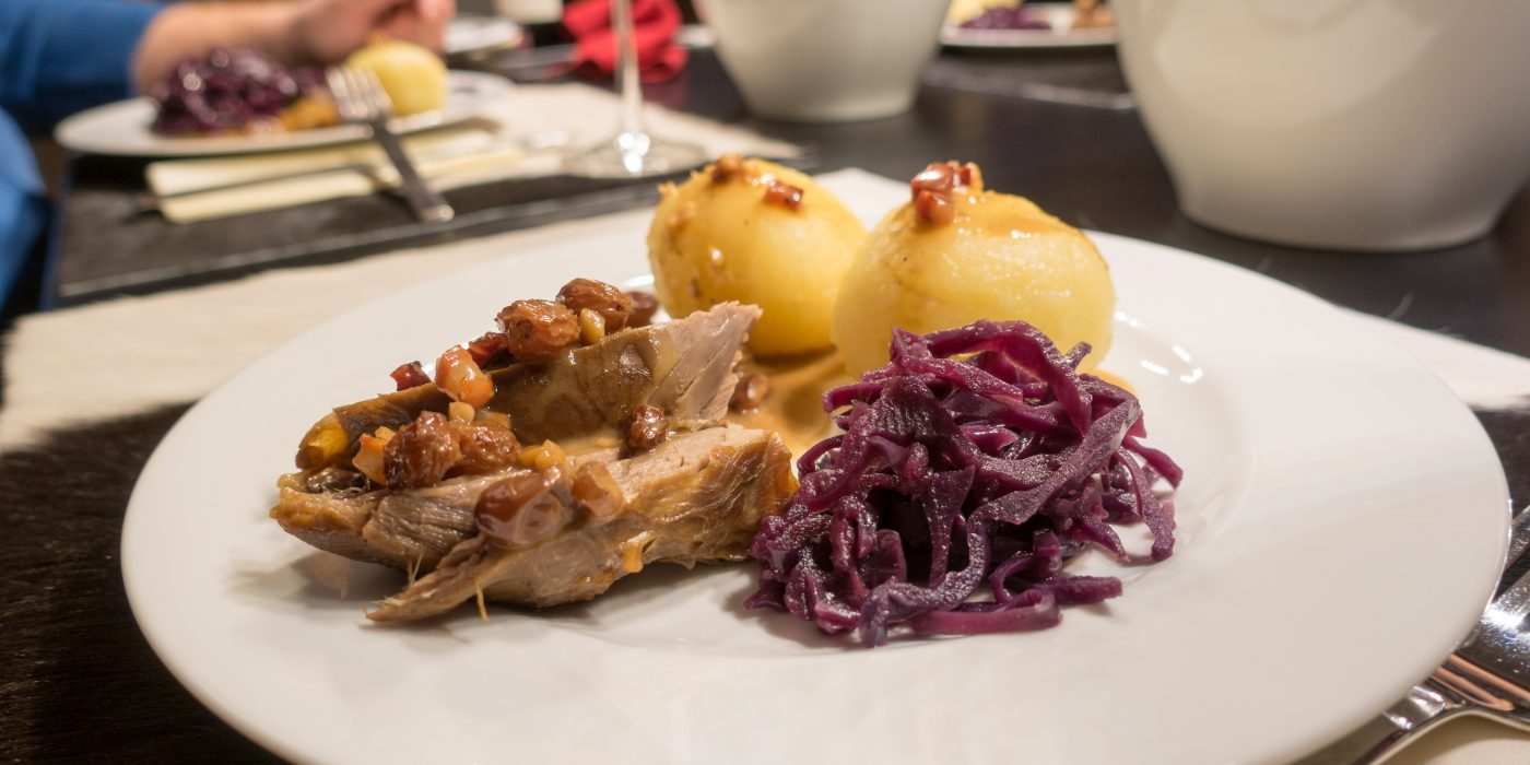 Sauerbraten of deer with marinated with dark beer, dumplings and red cabbage