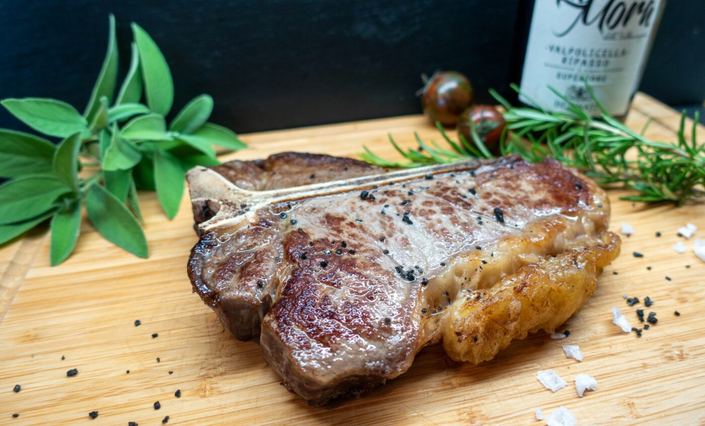 Fried T-bone steak on a wooden board